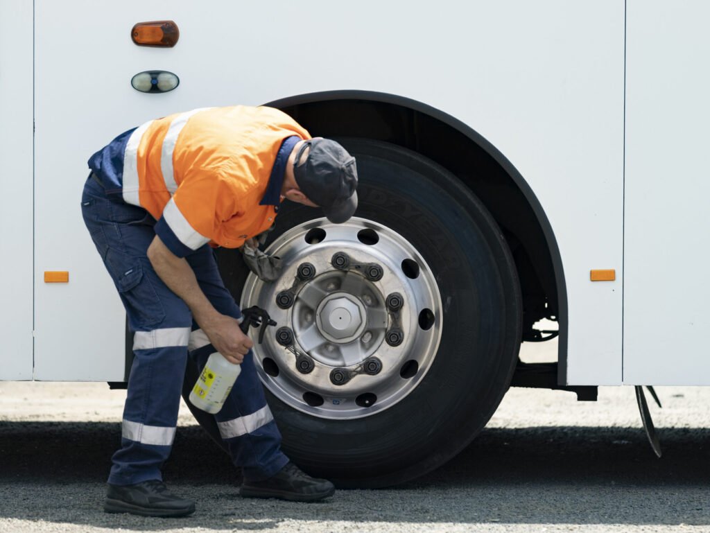 Employee working on bus wheel