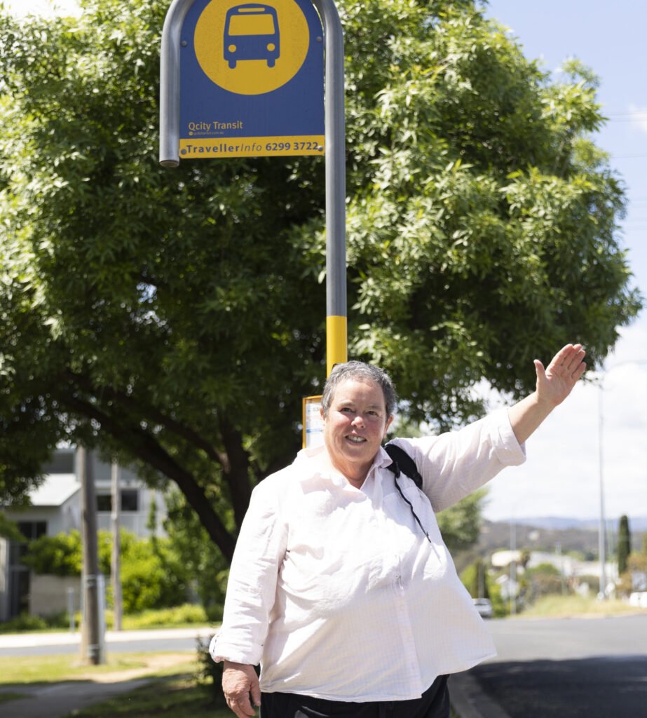 Woman waving bus down