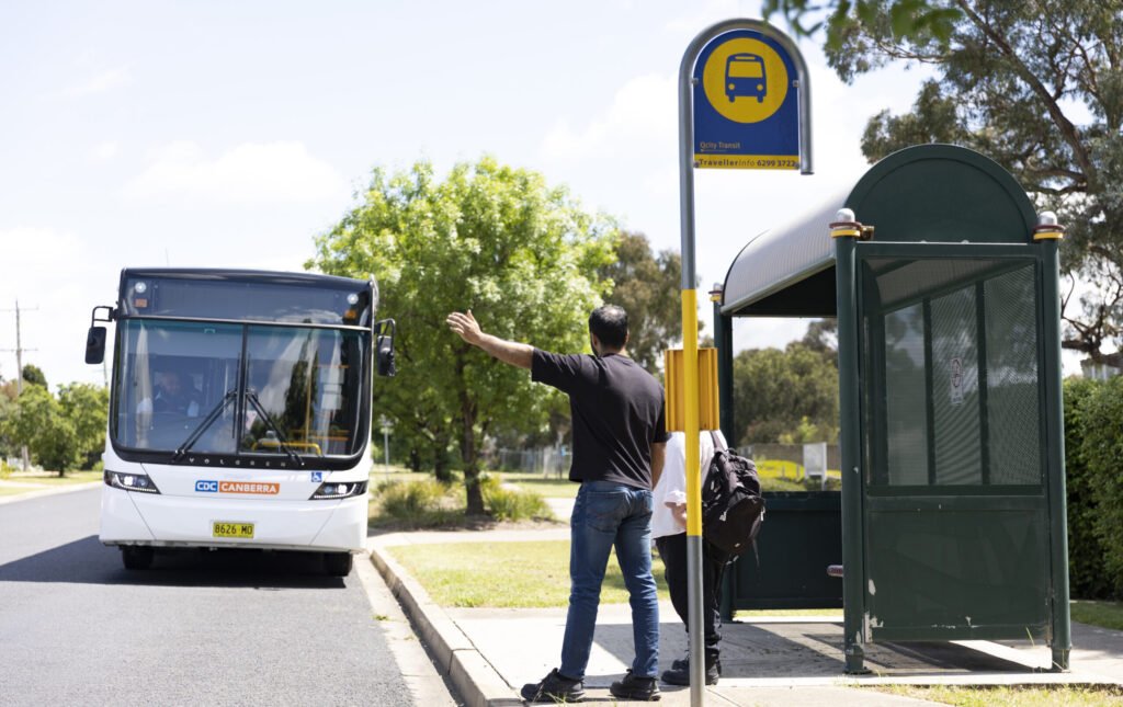 Man signaling bus to stop