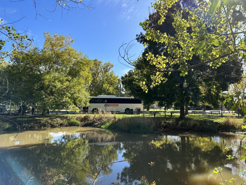 CDC Bus surrounded by nature and pond