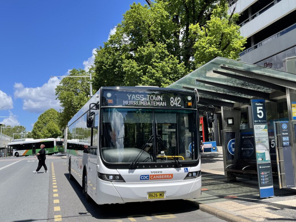 Bus waiting infront of destination sign